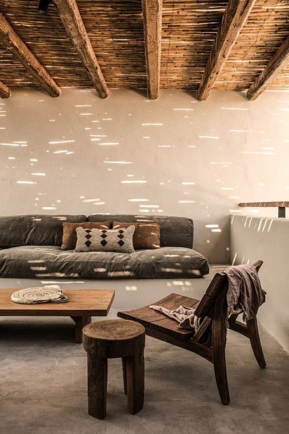 Neutral living room with bold tribal prints and natural wood accents
